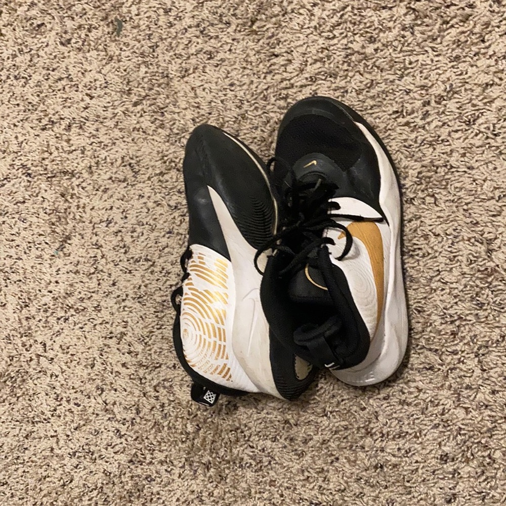 Nike black white and gold shoes